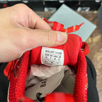 Balenciaga size label inside red sneaker with fabric lining and lace ties