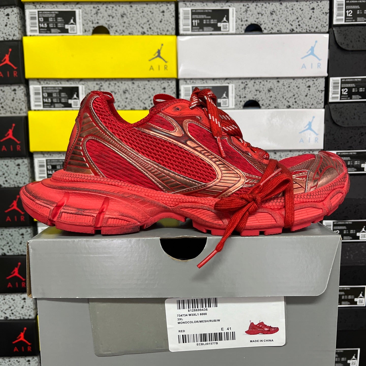 Red lace-up athletic sneaker with lace-up closure and chunky molded sole