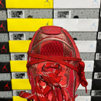 Red lace-up sneaker with mesh-like tongue and padded collar opening