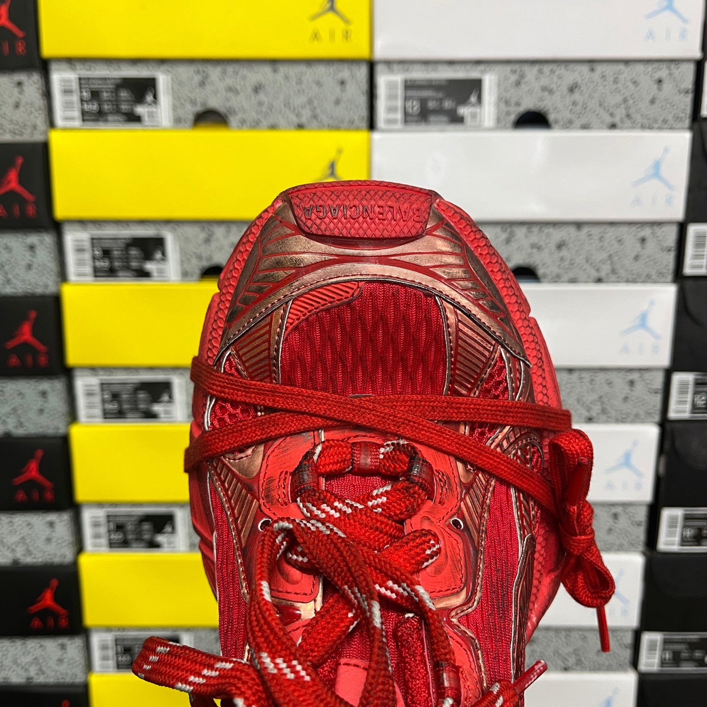 Red lace-up sneaker with mesh-like tongue and padded collar opening
