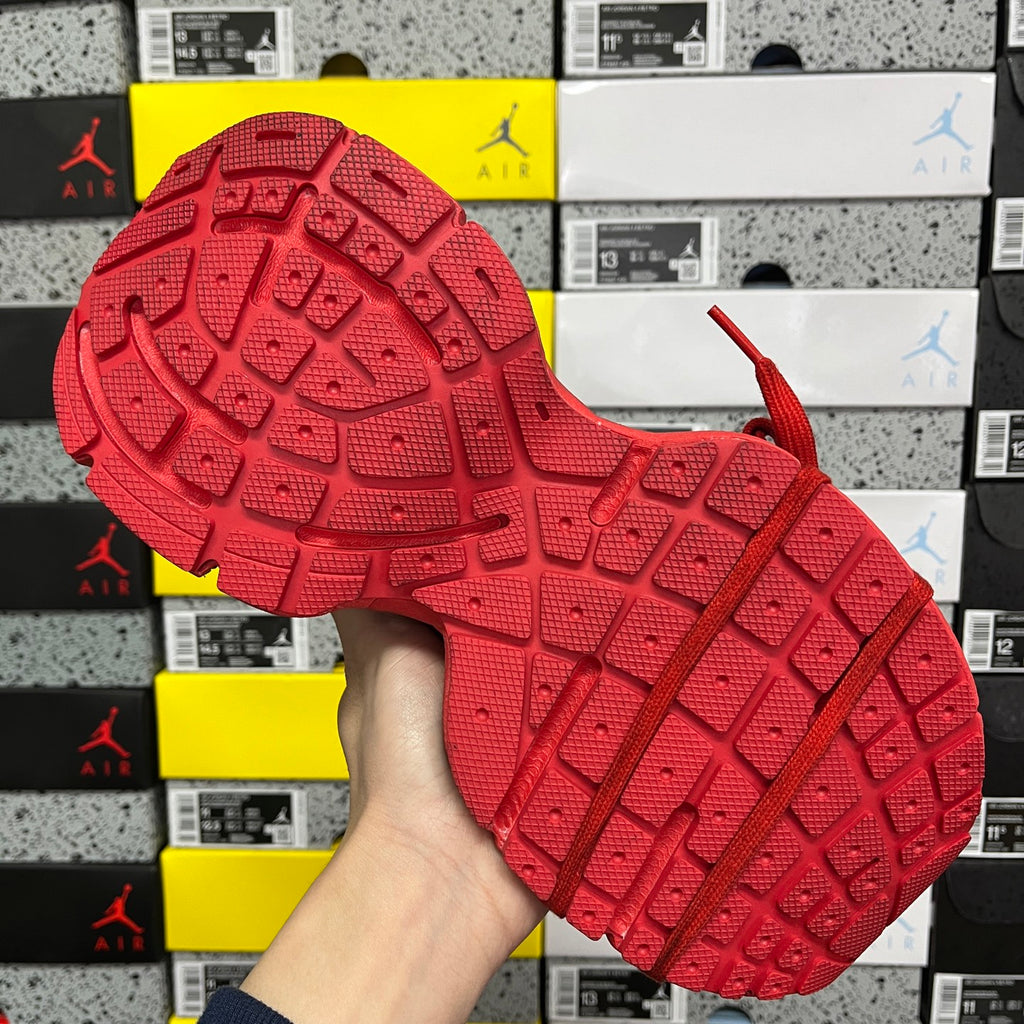 Red sneaker outsole with deep tread pattern and molded traction lines