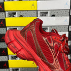 Red lace-up sneaker with gold-toned panel accents and textured toe area
