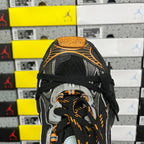 Black sneaker toe with lace-up front, silver trim, and orange braided laces