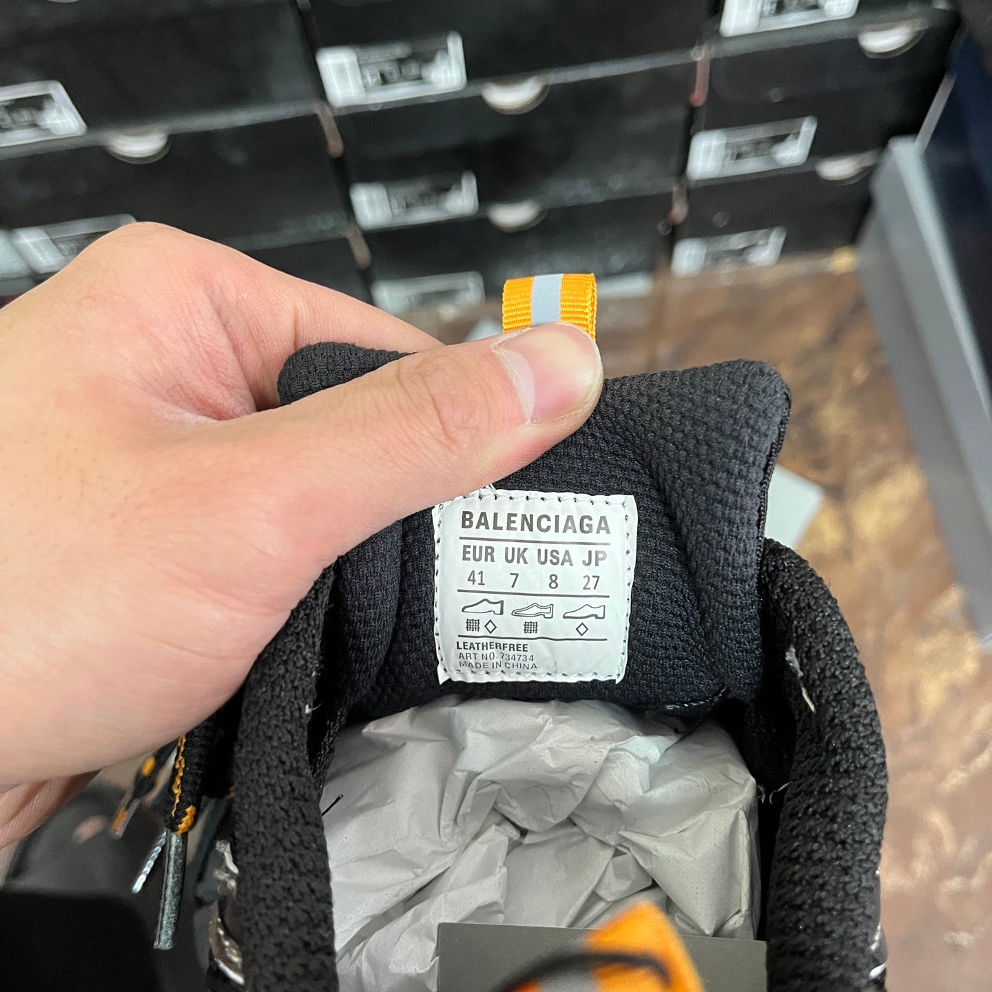 Inside label on black sneaker tongue with size and brand text