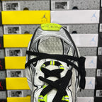 Silver running sneaker with black laces and neon green logo on tongue