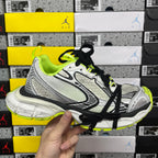 Silver and black running sneakers with neon green laces and accents