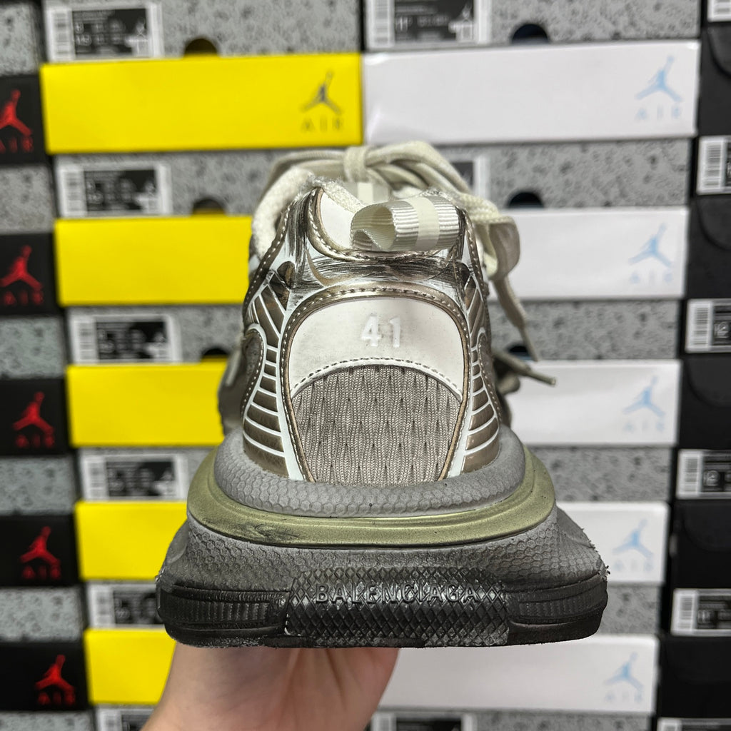 Light gray unisex sneakers heel view with rear pull tab and cushioned sole