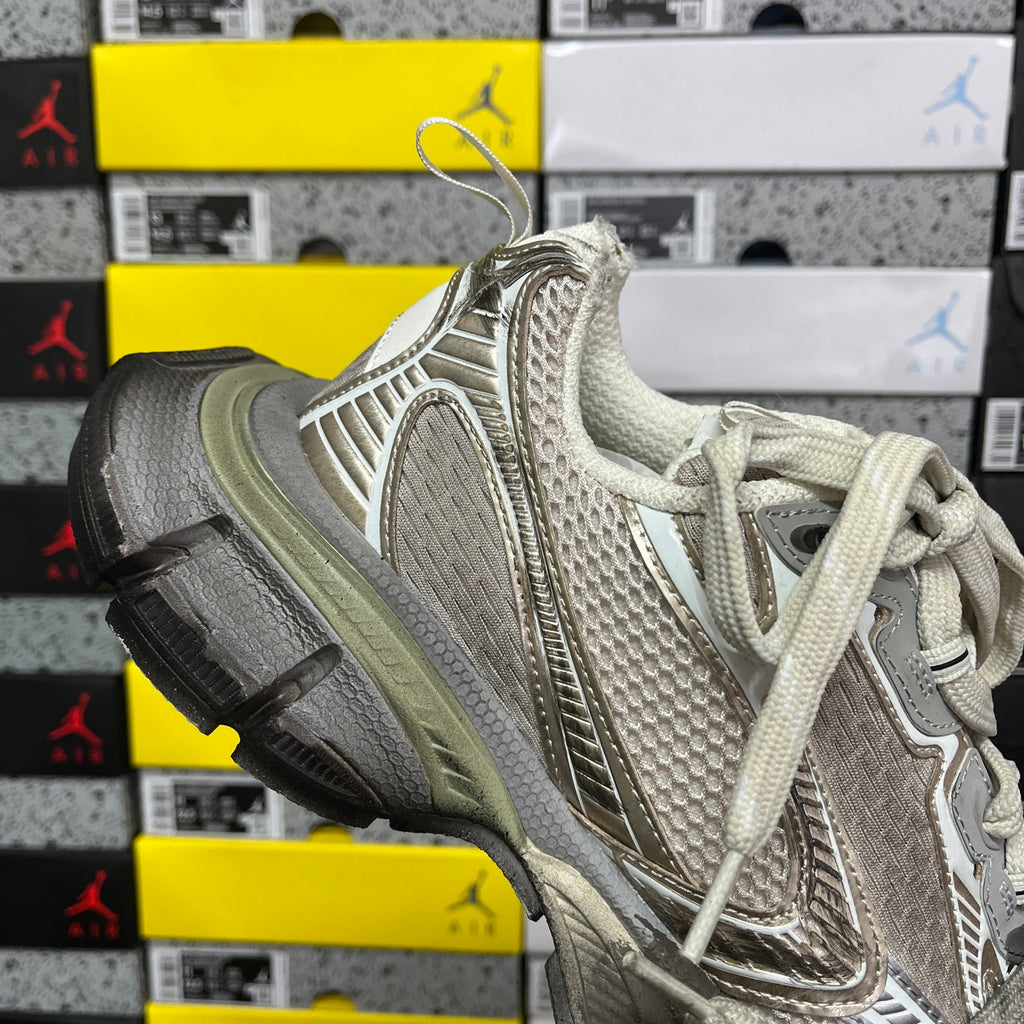 Light gray and metallic unisex sneakers with lace-up front and sculpted midsole