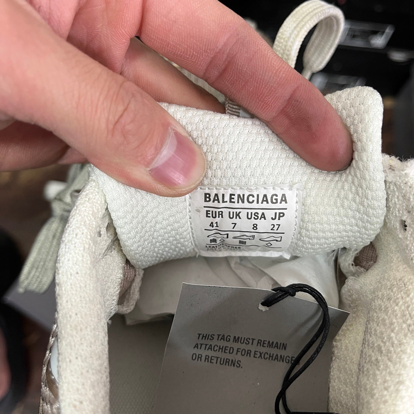 White sneaker tongue label showing BALENCIAGA size and fabric care tag