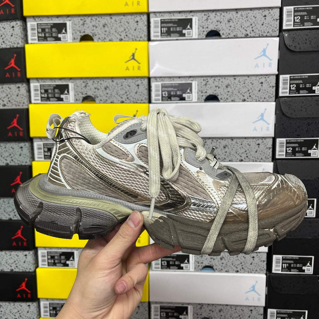 Light gray unisex sneakers front and side view with lace-up closure