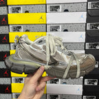 Light gray unisex sneakers front and side view with lace-up closure