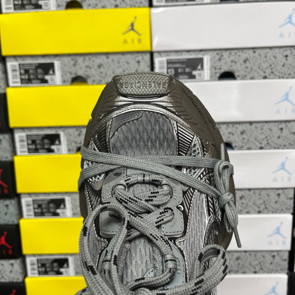 Unisex gray sneaker close-up of laces and cushioned tongue with pull tab