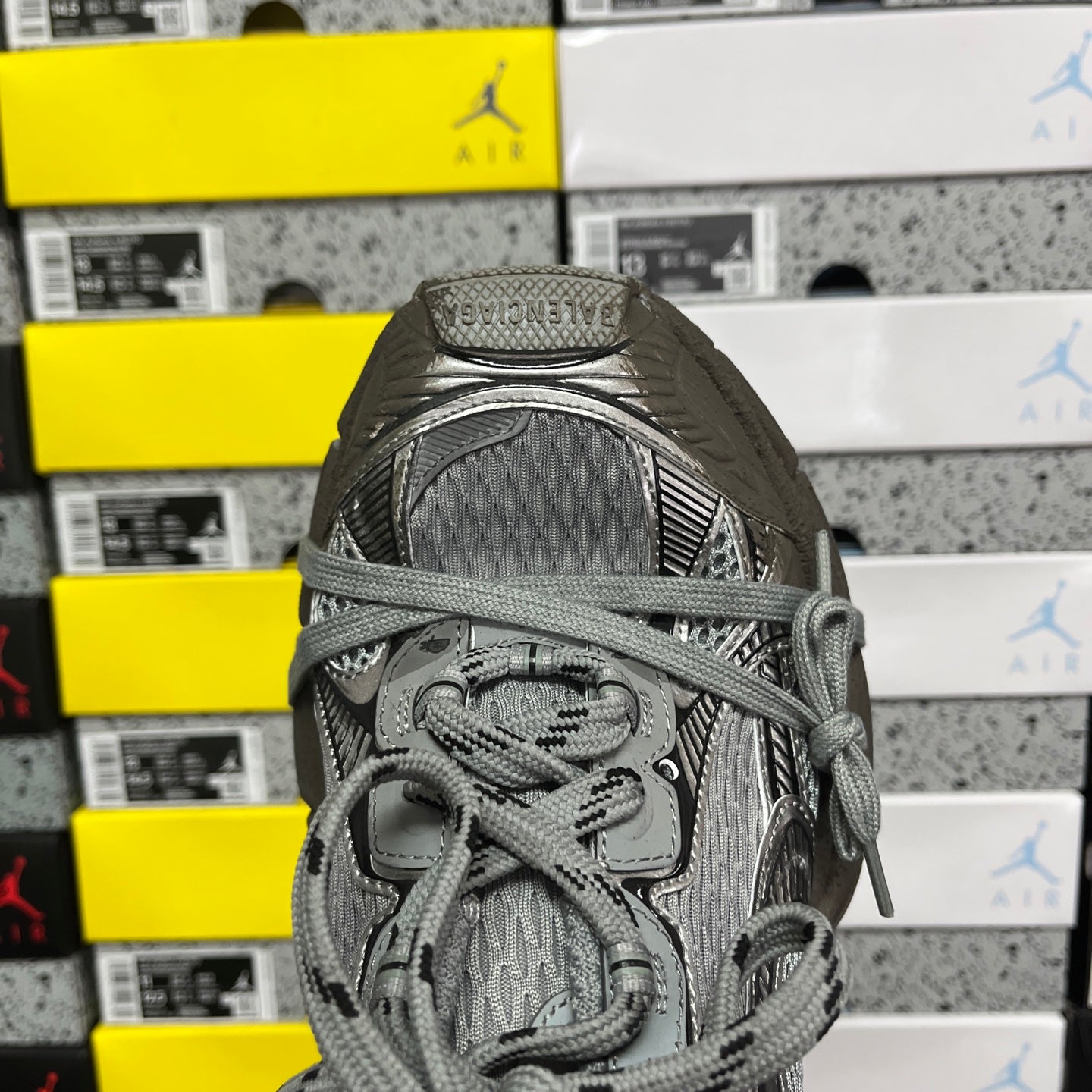 Unisex gray sneaker close-up of laces and cushioned tongue with pull tab