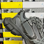 Unisex gray sneaker front with perforated mesh upper and lace-up design