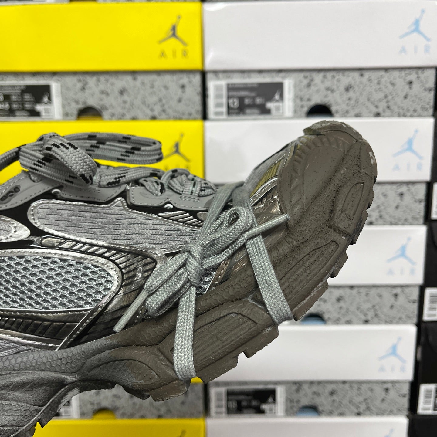 Unisex gray sneaker side view with thick rubber sole and lace-up closure
