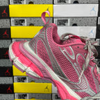 Pink and gray lace-up running sneakers with silver side accents and cushioned sole