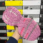 Pink rubber outsole with patterned tread and gray lace loops