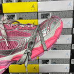 Pink and gray running sneakers with gray laces and textured heel detail