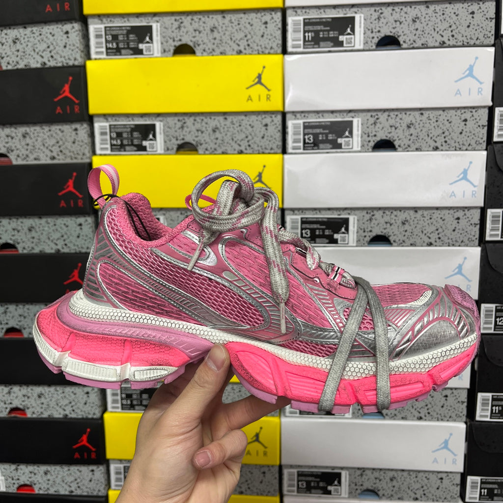 Pink and gray lace-up running sneakers with silver logo and chunky pink midsole