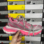 Pink and gray lace-up running sneakers with silver logo and chunky pink midsole