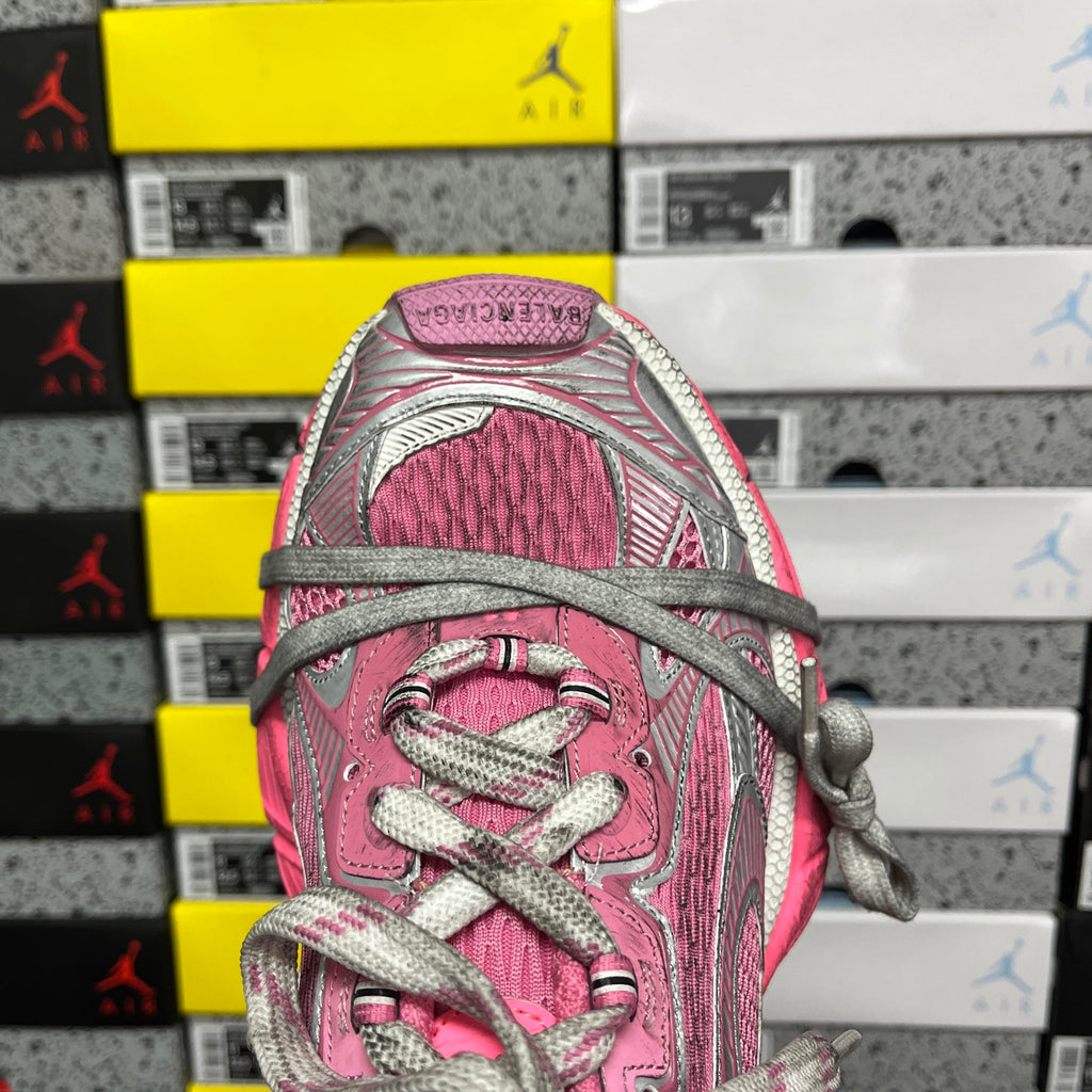 Pink knit sneaker tongue and lace area with gray eyelets and woven laces