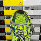 Close-up of neon green and blue shoe upper with gray laces and textured panel