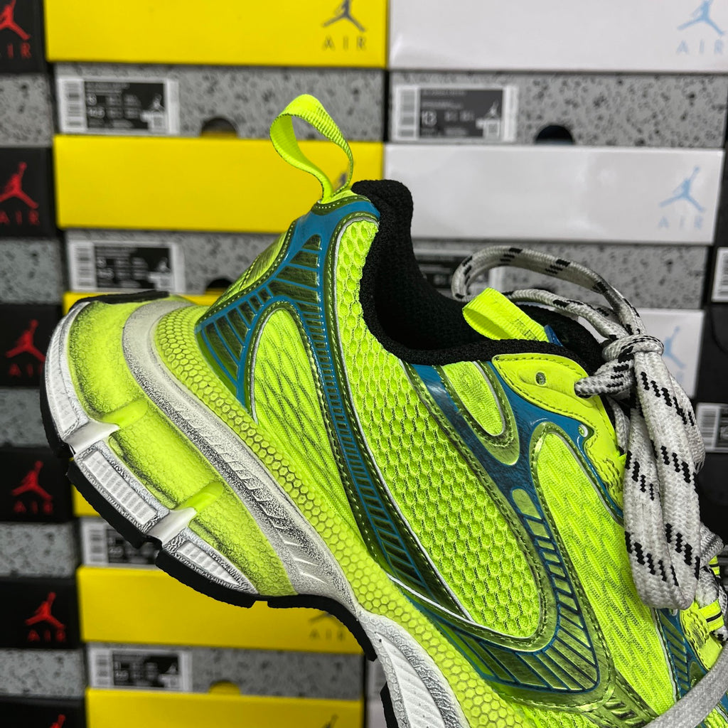Neon green and blue lace-up running shoe with gray laces and black heel collar