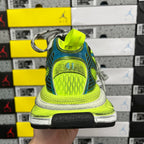 Heel view of neon green and blue running shoe with yellow hang tag and 41 patch