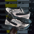 Dark lace-up sneakers with white logo panels and thick molded rubber sole