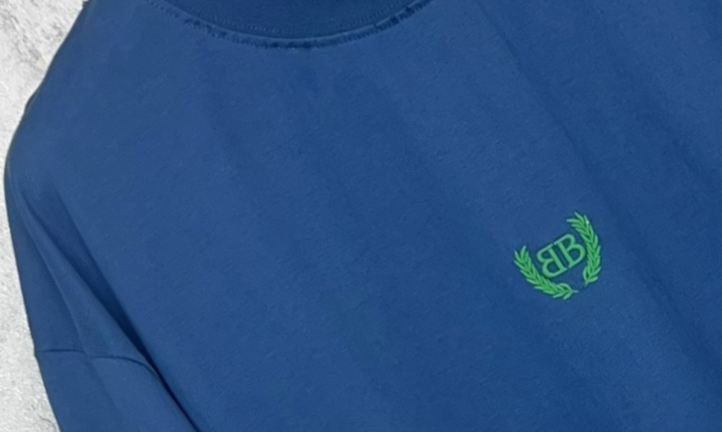 Balenciaga blue T-shirt with green logo on chest and short sleeve