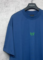 Balenciaga blue oversized T-shirt with crew neck and small green logo at chest