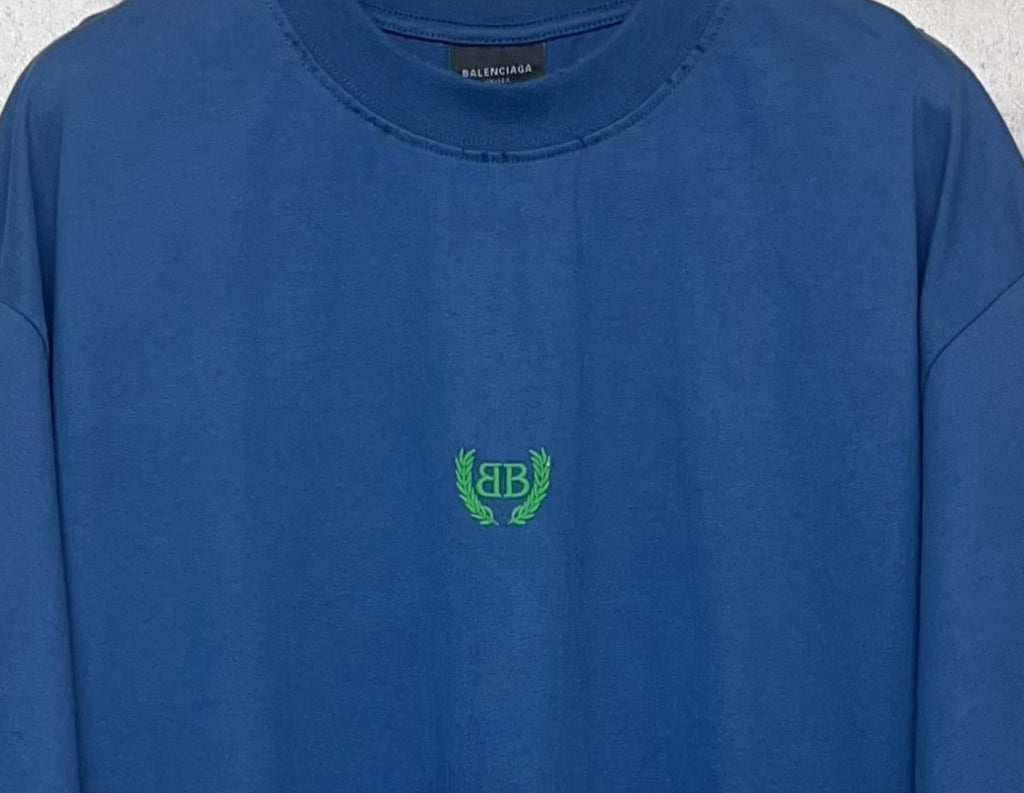 Balenciaga blue T-shirt neckline and green logo at center chest