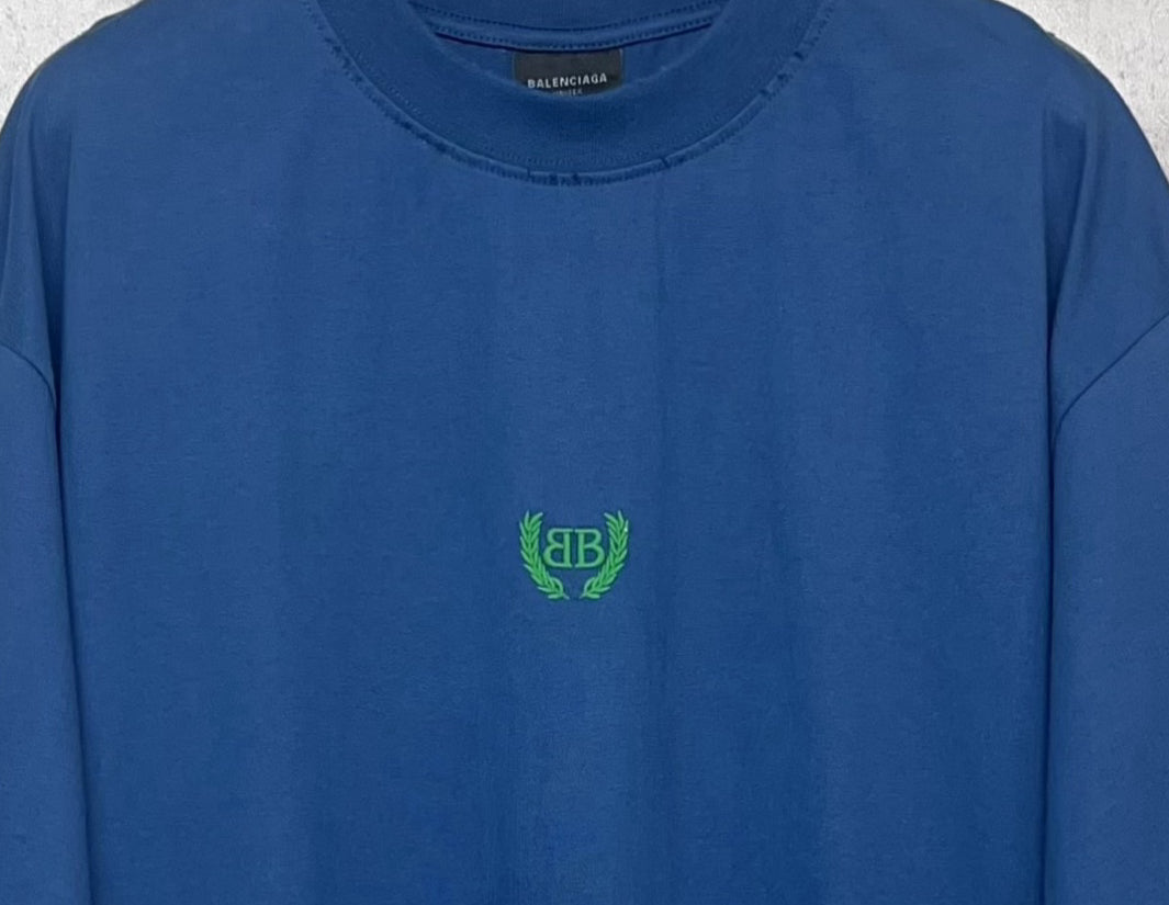 Balenciaga blue T-shirt neckline and green logo at center chest