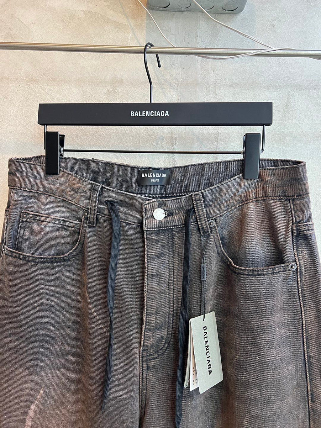 Balenciaga denim pants with drawstring waistband and front button closure