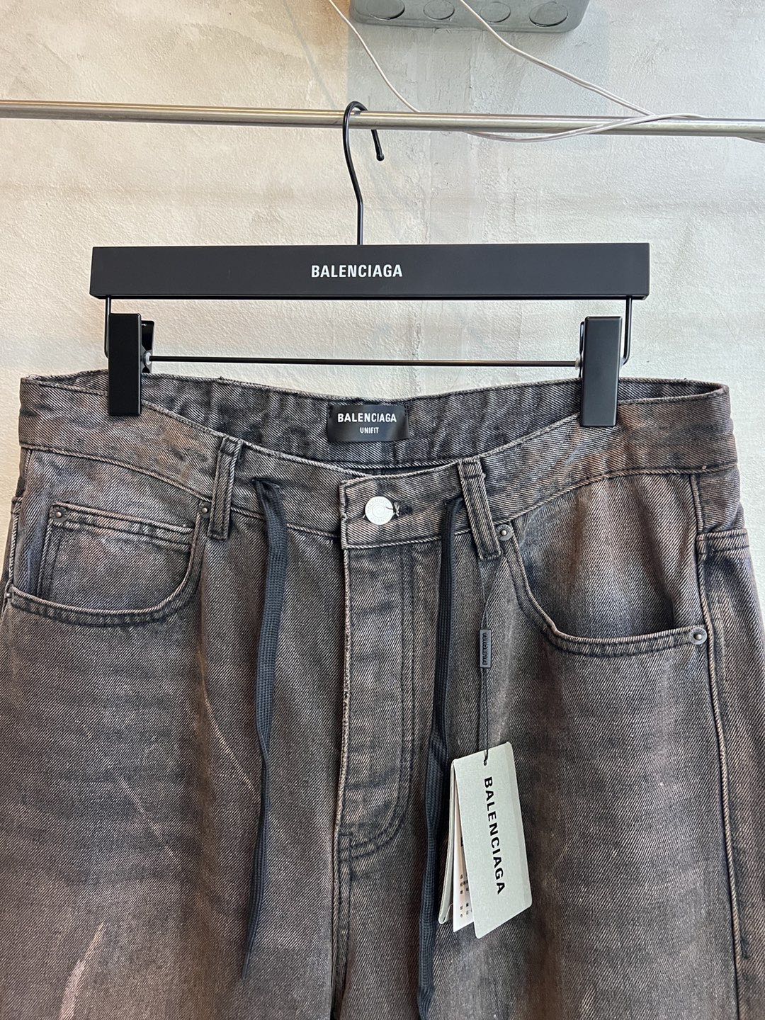 Balenciaga denim pants with drawstring waistband and front button closure