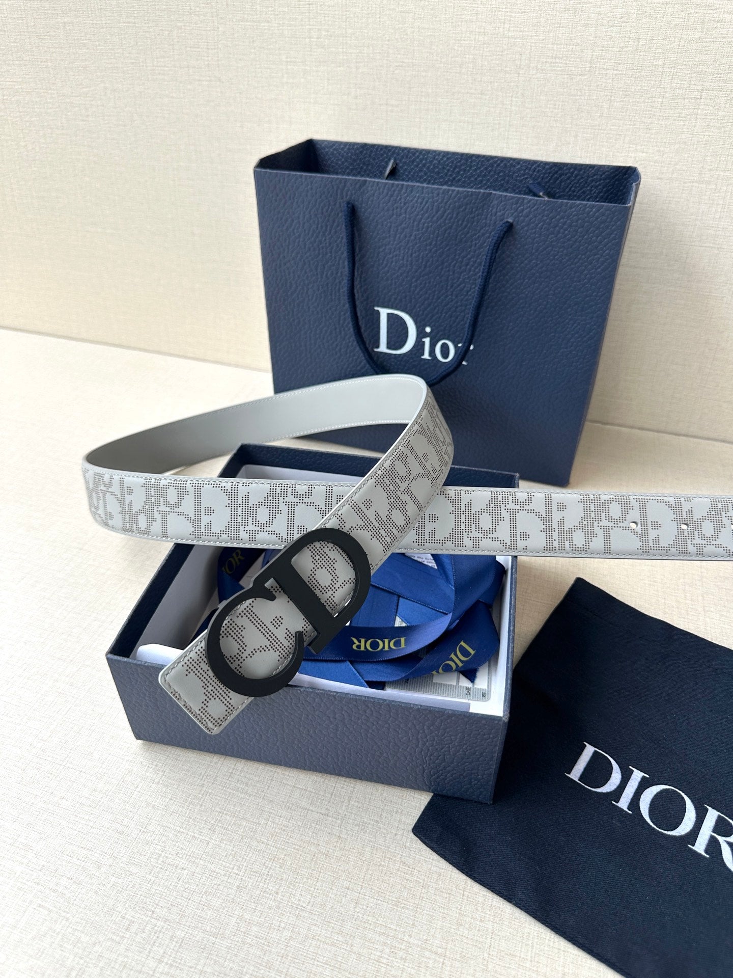 Dior belt with gift box, light gray logo strap and black CD buckle.