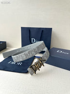 Dior belt stacked view, light gray logo strap with gold-and-black Dior buckle