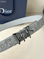Dior belt close-up, light gray logo strap with black-and-gold Dior buckle