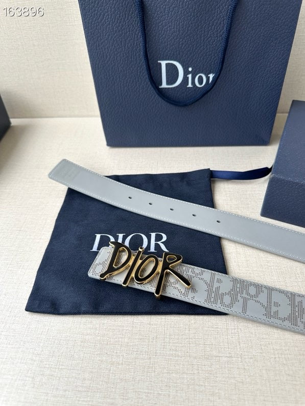 Dior belt flat lay, light gray logo strap with gold-and-black buckle