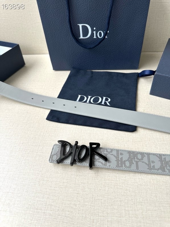 Dior belt laid flat: light gray monogram strap with black Dior buckle