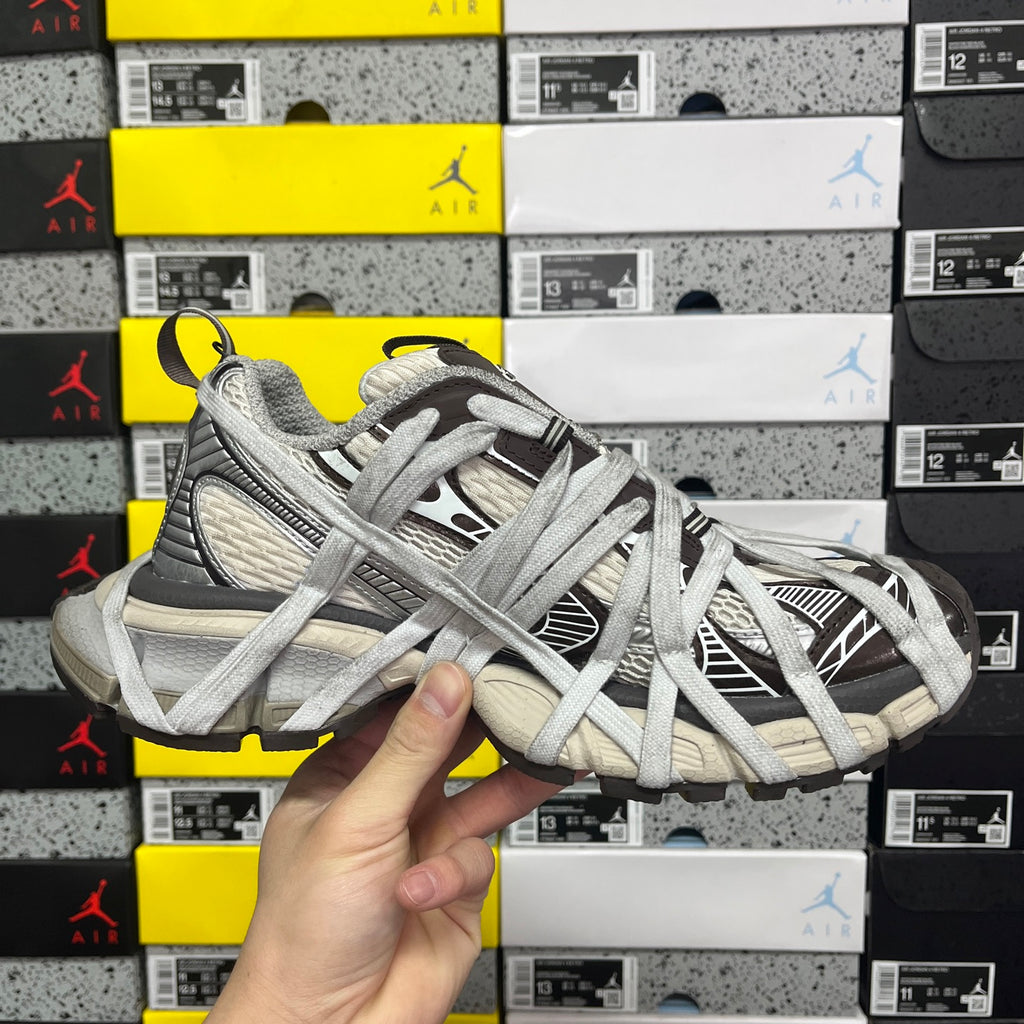 Unisex sneakers front three-quarter view with gray laces and black striped sections