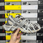 Unisex sneakers front three-quarter view with gray laces and black striped sections