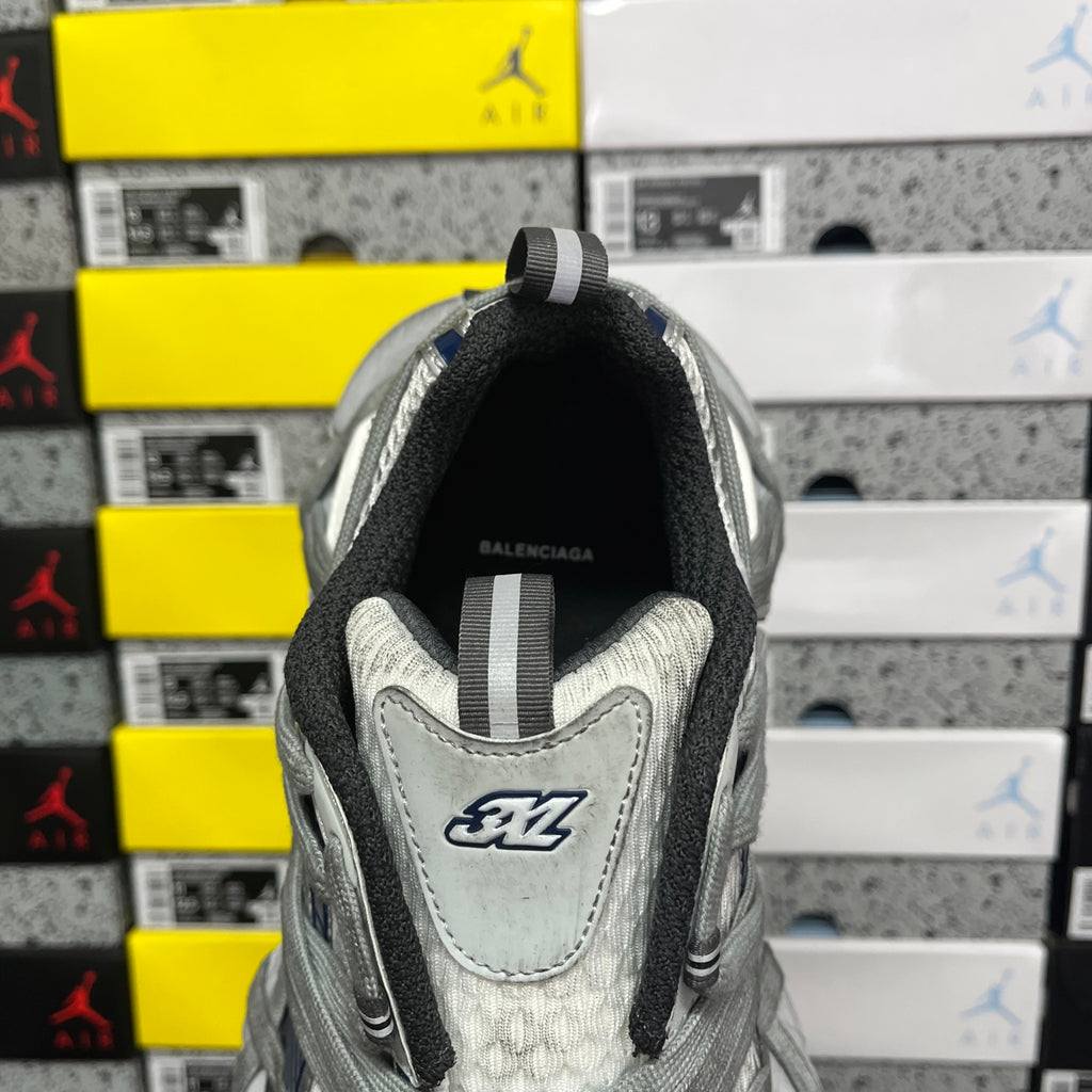 Balenciaga unisex sneakers, heel view with grey upper and BALENCIAGA logo label