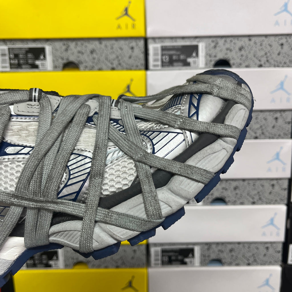Balenciaga unisex sneakers, side view of grey mesh upper with blue tread and laces
