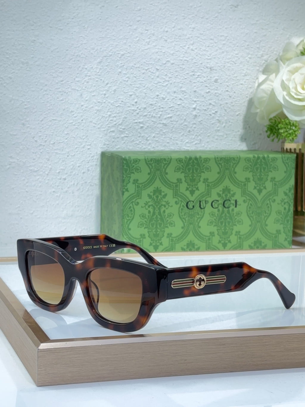 Tortoiseshell oversized sunglasses with brown lenses and gold logo bridge detail