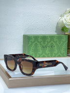 Tortoiseshell oversized sunglasses with brown lenses and gold logo bridge detail