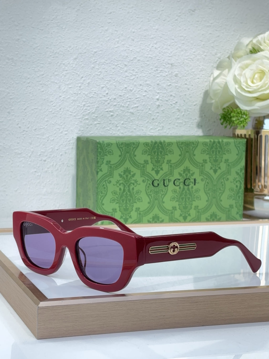 Burgundy red oversized sunglasses with tinted lenses and gold logo bridge detail
