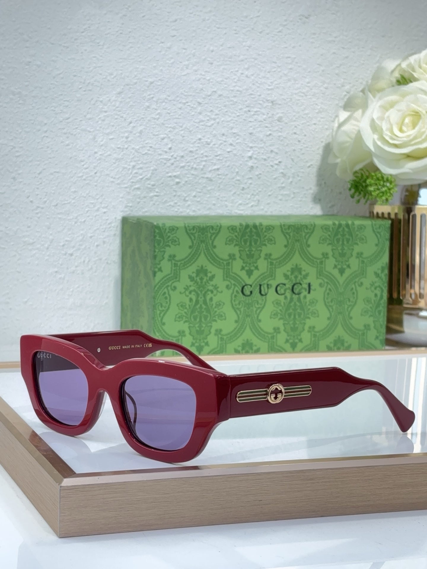 Burgundy red oversized sunglasses with tinted lenses and gold logo bridge detail