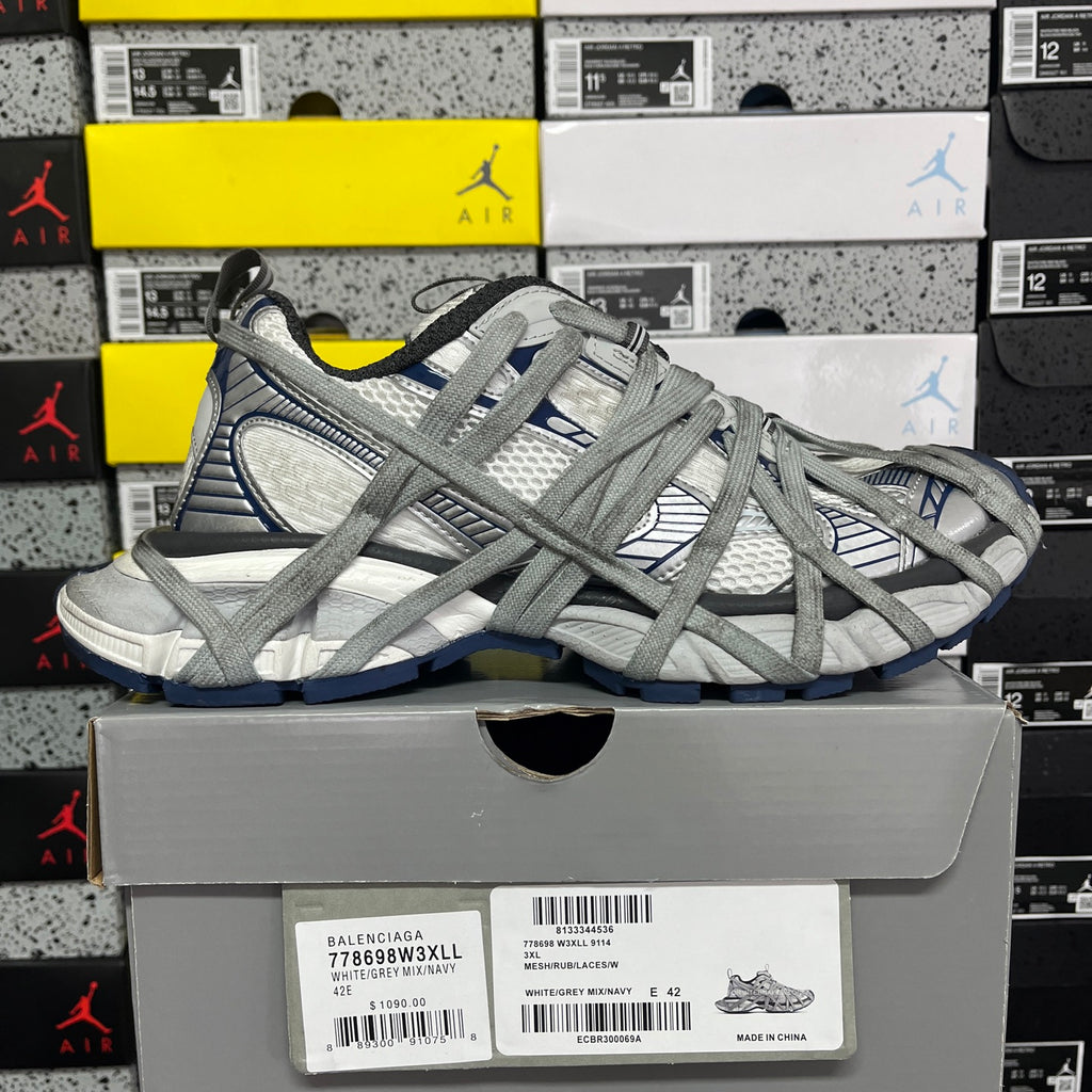 Balenciaga unisex sneakers on box, grey knit upper with blue detailing and lace-up design