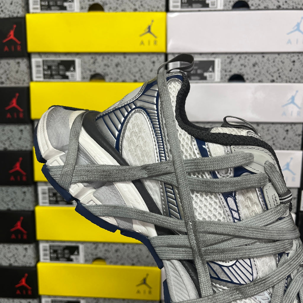 Balenciaga unisex sneaker, grey and white layered upper with dark heel trim and blue detailing